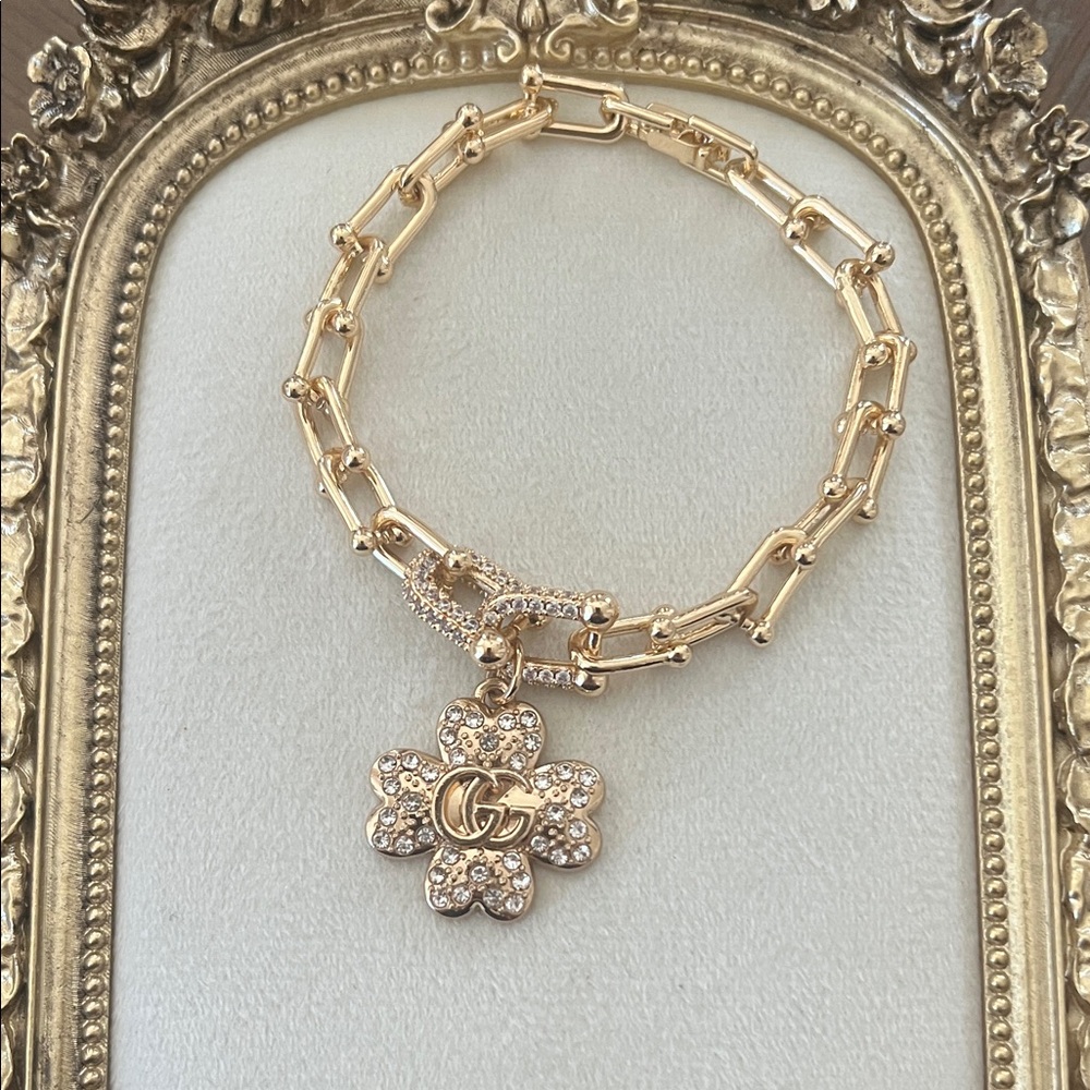 Gucci clover charm with gold bracelet